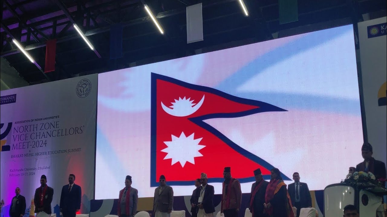 The stage at Kathmandu University in Dhulikhel, with Nepal's flag on the big screen, from NishantSAMA's first IRL stream on 15 February 2024